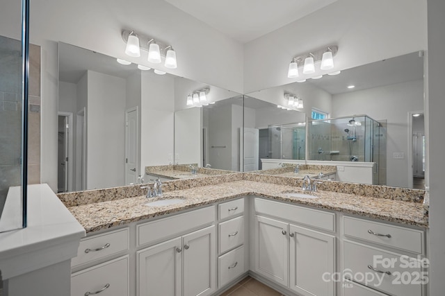 bathroom with vanity, a shower with shower door, and tile patterned floors