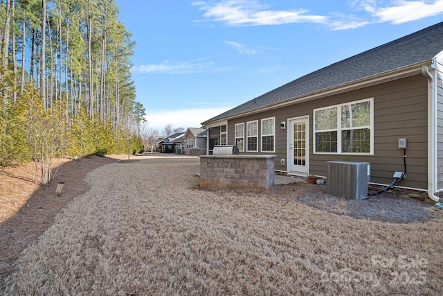 rear view of property featuring central AC unit