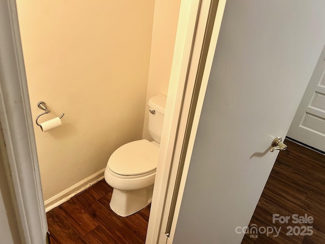 bathroom featuring wood-type flooring and toilet