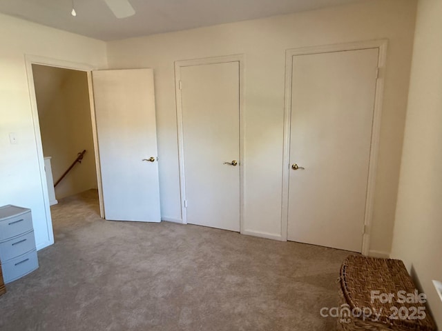 unfurnished bedroom featuring ceiling fan and carpet flooring