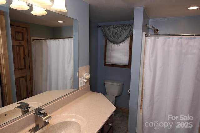 bathroom featuring vanity, curtained shower, and toilet