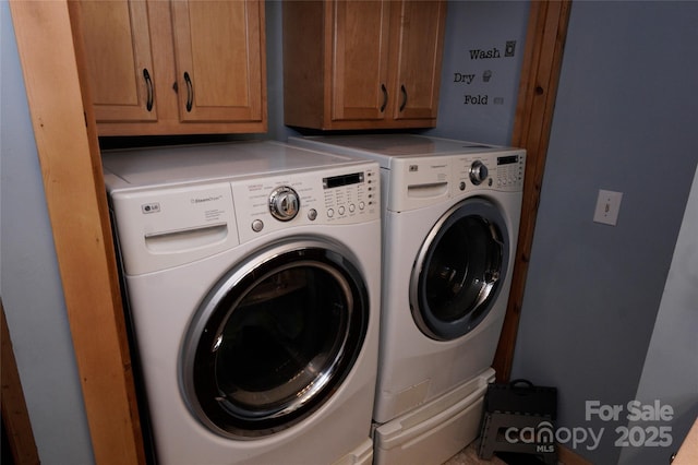 laundry area featuring cabinets and washer and dryer