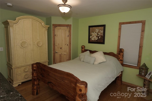 bedroom featuring dark wood-type flooring