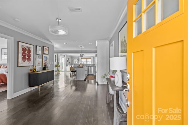 entrance foyer with crown molding and dark hardwood / wood-style flooring