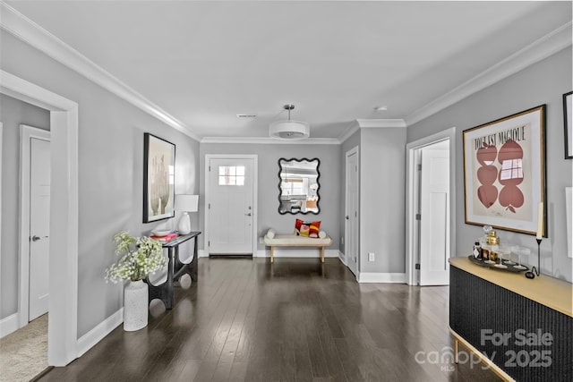 foyer entrance with dark hardwood / wood-style flooring and crown molding