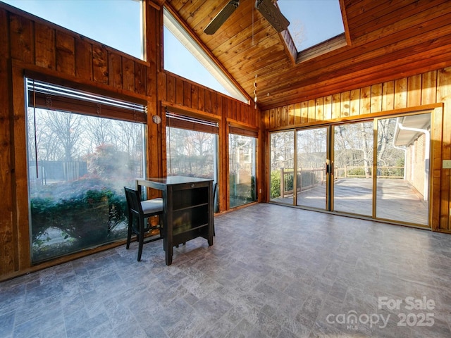 sunroom featuring ceiling fan, wood ceiling, and lofted ceiling with skylight