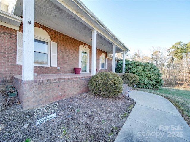 view of exterior entry with covered porch