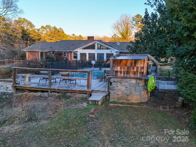 rear view of property with a swimming pool side deck