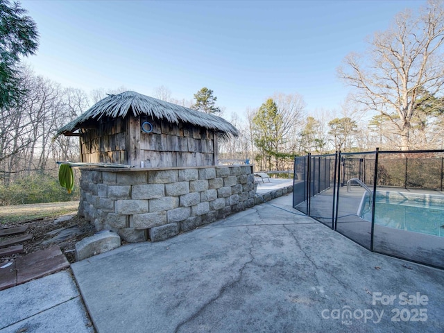 view of patio with a fenced in pool