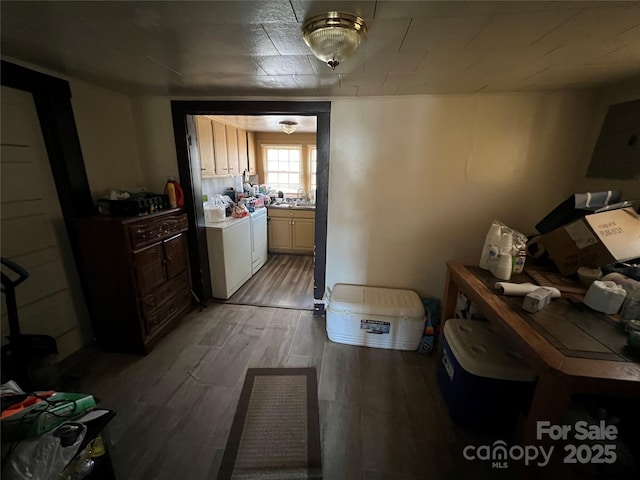 hall featuring sink and independent washer and dryer