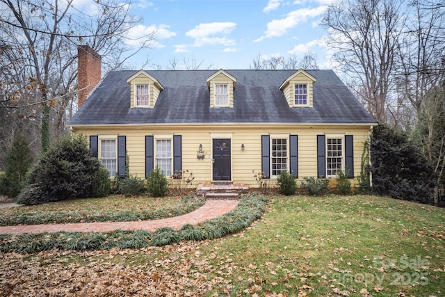 cape cod home featuring a front lawn