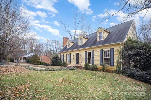 cape cod house featuring a front yard