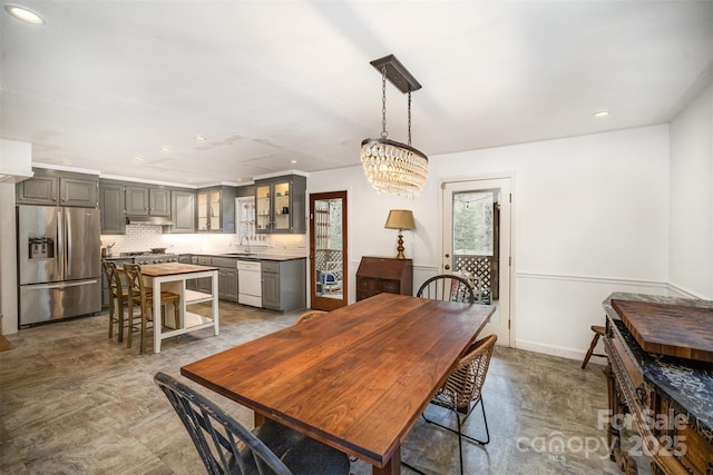 dining area with sink and an inviting chandelier