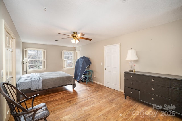 bedroom with ceiling fan and light hardwood / wood-style flooring