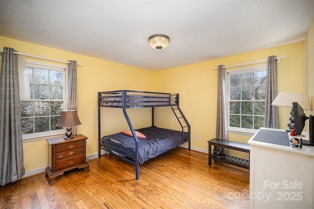 bedroom with wood-type flooring and a textured ceiling