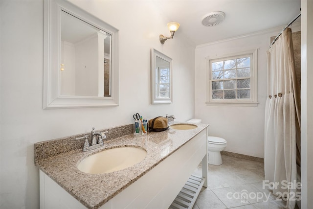 bathroom featuring vanity, crown molding, toilet, and tile patterned floors