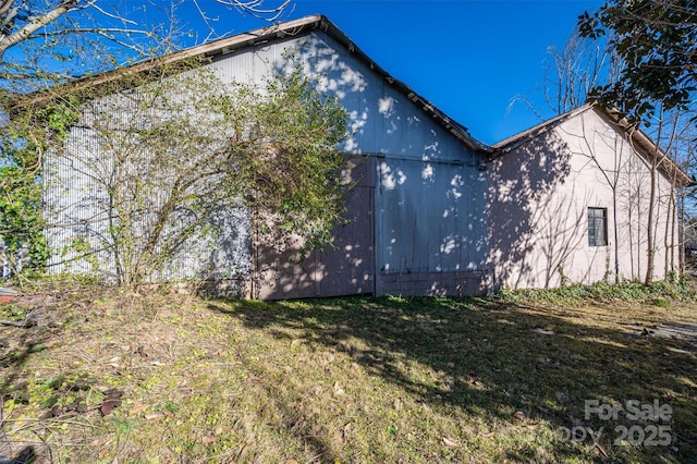 view of side of home featuring a yard