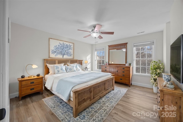 bedroom with light hardwood / wood-style floors and ceiling fan