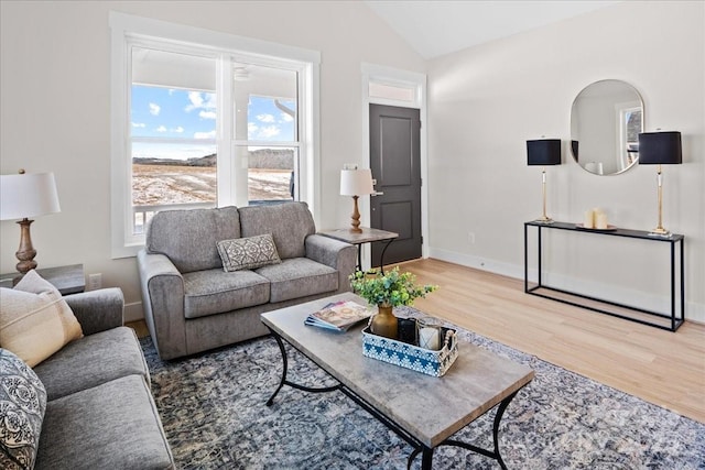 living room featuring hardwood / wood-style floors and vaulted ceiling