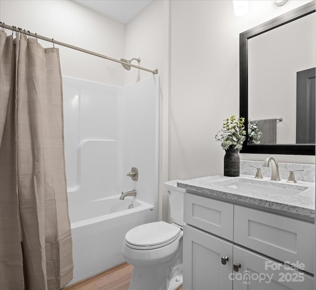 full bathroom with toilet, wood-type flooring, shower / tub combo with curtain, and vanity