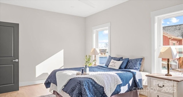 bedroom featuring light hardwood / wood-style flooring and multiple windows