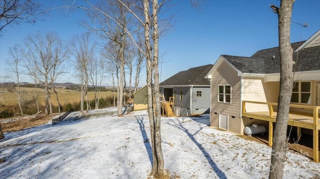 snow covered property featuring a wooden deck