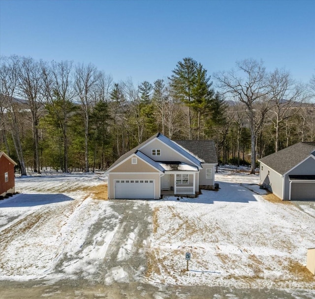 view of snow covered exterior with a garage