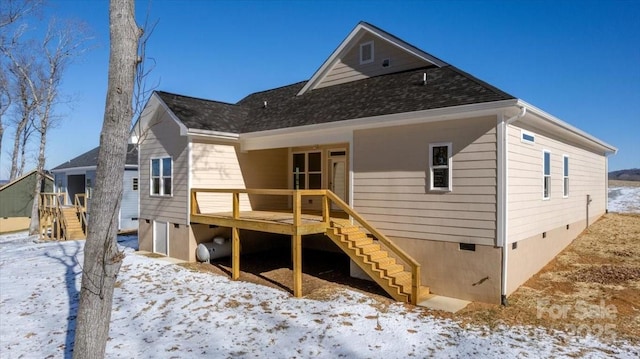 snow covered property with a deck