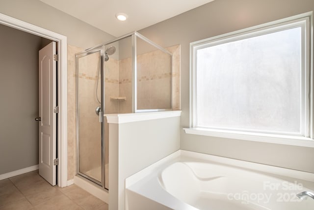 bathroom featuring independent shower and bath and tile patterned flooring