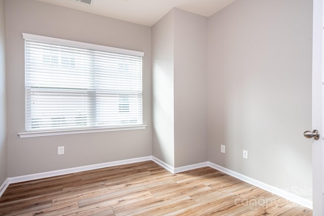 empty room with light hardwood / wood-style floors