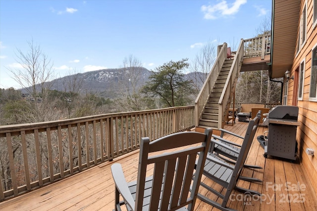 wooden terrace with area for grilling and a mountain view