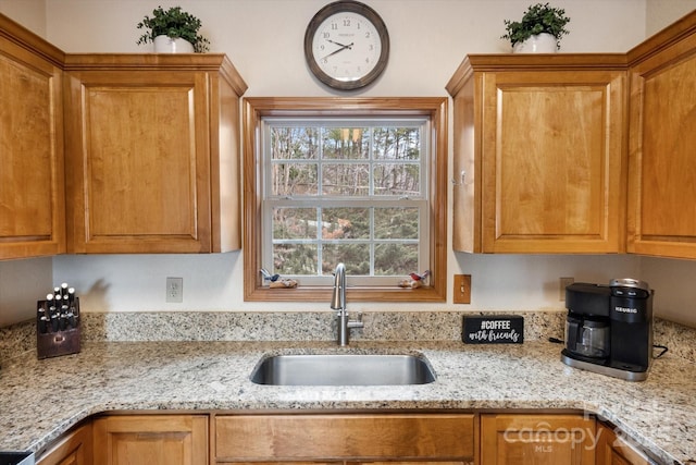 kitchen with sink and light stone counters