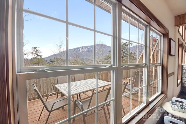 sunroom / solarium featuring a mountain view