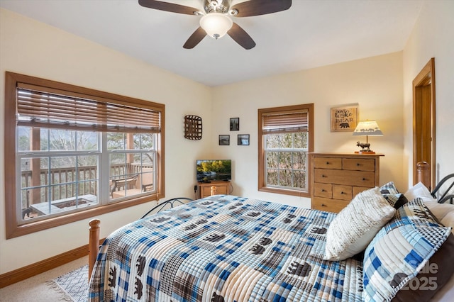 bedroom featuring light colored carpet and ceiling fan