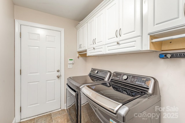 washroom featuring independent washer and dryer and cabinets