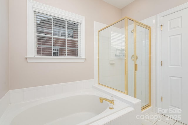 bathroom with independent shower and bath and tile patterned flooring