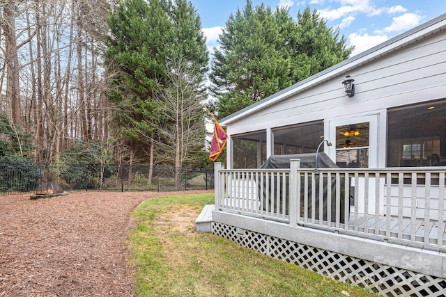 view of yard featuring a wooden deck and a sunroom