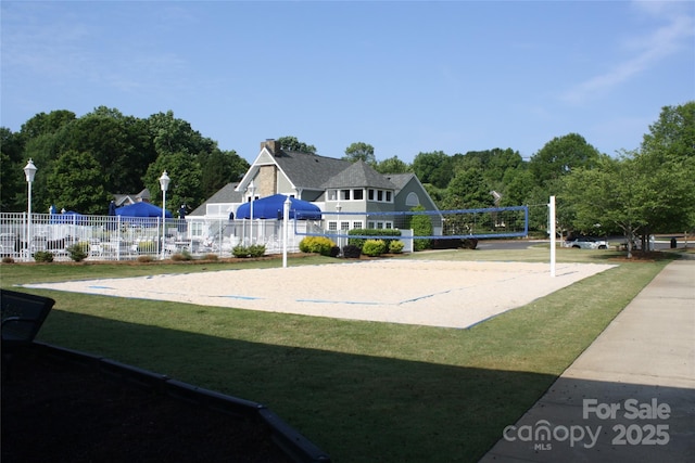 view of community with a yard and volleyball court