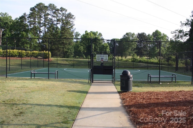 view of tennis court with a yard and basketball court