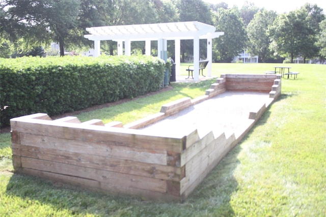 exterior space featuring a pergola and a lawn