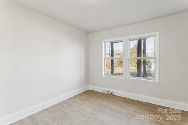 unfurnished room featuring light hardwood / wood-style floors