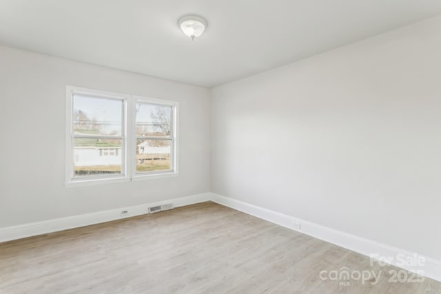 spare room featuring light wood-type flooring