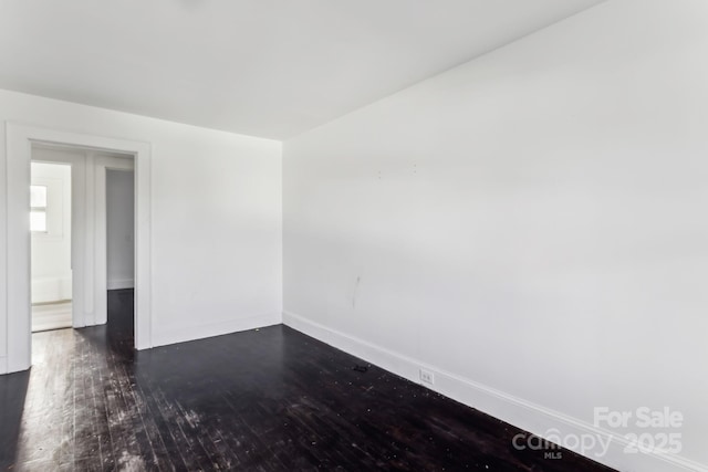 empty room featuring dark wood-type flooring