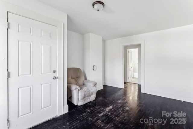 unfurnished room with dark wood-type flooring