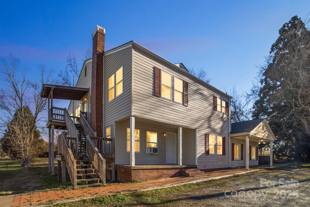 view of side of property with covered porch and cooling unit