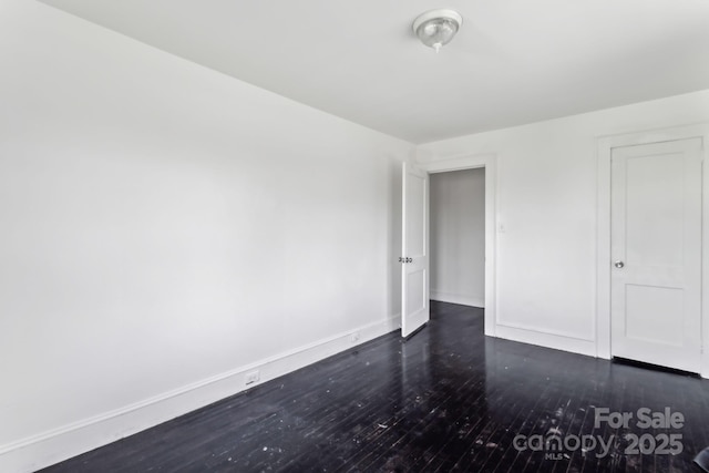 unfurnished bedroom featuring dark wood-type flooring