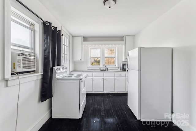 kitchen featuring white appliances, white cabinetry, cooling unit, dark hardwood / wood-style flooring, and sink