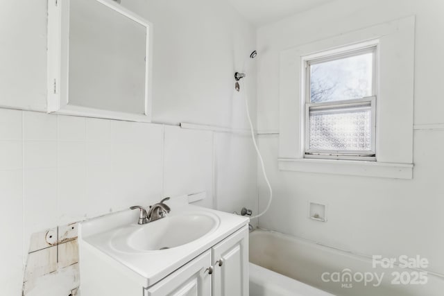 bathroom with backsplash, shower / tub combination, and vanity