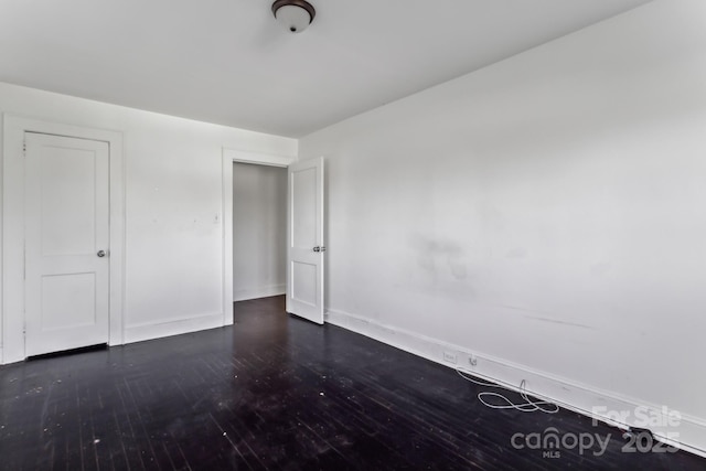 unfurnished bedroom featuring dark hardwood / wood-style flooring