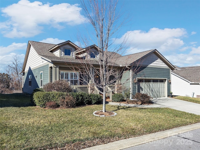 view of front facade featuring a front yard, a garage, and covered porch